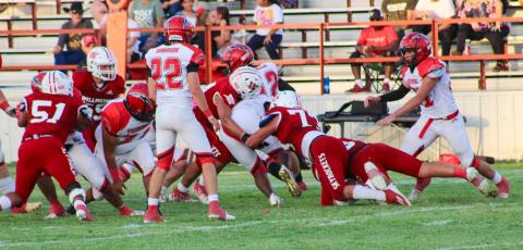 Skyrockets Ethan Nevarez (44) and Dalton Holland (73) jump on the tackle, while Ramon Rodriguez (51), Jackson Jones (55) and Gatlin Guy (3) attempt to hold off the Bombers for a successful tackle Friday night, Aug. 25. The Skyrockets shutout the Bombers 30-0 for their first home game of the season on Powell Field. The Red River Sun/Shauna Salinas