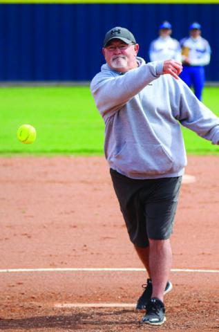 Honorary guest Ronnie Sarge Bentley throws the first pitch during the Lady Cats’ game against the Slaton Tigerettes Saturday, March 23 in Childress. Through the Lens of Liz/Elizabeth Oronia