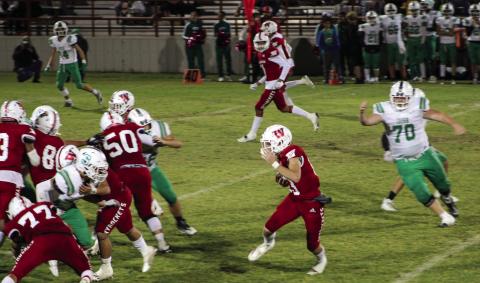 Skyrocket Nixon Folk (13) runs the ball down the field behind Wellington’s offensive line, slipping past the Irish in a district-opening 36-0 shutout. The Red River Sun/Shauna Salinas