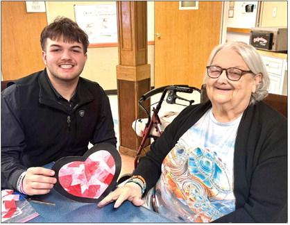 Memphis High School National Honor Society members share the love at Memphis Convalescent Center Wednesday, Feb. 11, stopping by to complete a Valentine’s Day craft with residents. Memphis Convalescent Center