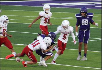 Junior varsity Rocket Conner Bowen (11) takes down a Spearman Lynx near the endzone with Carson Kane (5), Kingston Molina (51) and KJ Molina (64) assisting in the stop. Wellington maintains its perfect 3-0 record with the 14-6 win Thursday, Sept. 14 at Lynx Stadium. The Red River Sun/Shauna Salinas