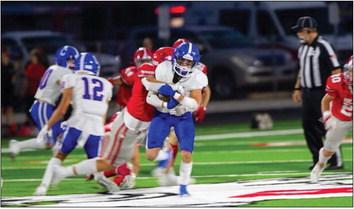 Childress’ Mark Willis carries a Holliday defender Friday, Sept. 15 at Eagle Stadium in Holliday. Press Pass Sports/Nicole Dill