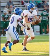 Childress quarterback Drake Rabe (15) hands the ball off to Da’Reon Mathis (20) Friday, Sept. 1 at Buckaroo Stadium. Photos by Childress High School Yearbook Staff