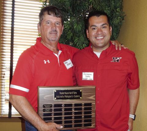 Wade Williams, left, Wellington High School (WHS) Class of 1983, shows appreciation for the honor of 2023 Rocket House Hall of Fame inductee during the 2023 Wellington Ex-Student Association reunion festivities Saturday morning, Aug. 5, 2023, at the Wellington Ritz Theatre lobby venue. WHS Principal Jermaine Cantu, WHS Class of 2002, served as master of ceremonies, announcing Williams as the honoree. The Red River Sun/Bev Odom