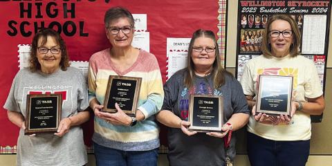 Ranee Foumentin, left, Debbie Scott, Georgia Brown and Dian Souder accept recognition upon their retirement for the years vested in Wellington Independent School District during the Friday, May 17 breakfast assembly at the Wellington High School Auditorium. Courtesy Photos
