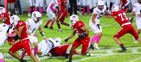 Wellington’s Anthony Ortiz (15) adds up yardage for the Skyrockets, while Dalton Holland (73), Travon Lewis (21), RJ Granadoz (60) and Dixon Dugan (50) hold Clarendon’s defense Friday, Oct. 11 at Powell Field in Wellington. The Red River Sun/Shauna Salinas