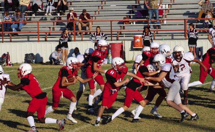 Eighth-grade Firecracker Callen Kane (8) rushes the ball to gain yards following his block Connor Bowen (11) and many other Firecrackers. Wellington shutout Clarendon 52-0 for its final game of the 2022 season Thursday, Nov. 3. The Red River Sun/Shauna Salinas