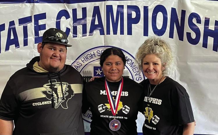 Senior powerlifter Emili Martinez, coached by assistant powerlifting coach Jose Duran, left, and powerlifting coach Michelle Branigan, right, brings home a fourth-place finish in weight class 198.