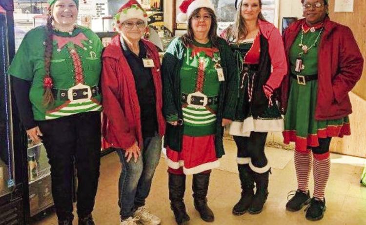 Market Square Supermarkets’ Angela Petree, left, Winnie Black, Velvet Burkenbine, Toni DeHerrera and Angie McDanel appear as Santa’s elves for Christmas Eve. The staff appreciates so many customers shopping local for a record sales day even with a 6 p.m. closing. The Wellington store closed Sunday, Dec. 25 so employees could spend time with family and friends. Courtesy Photo
