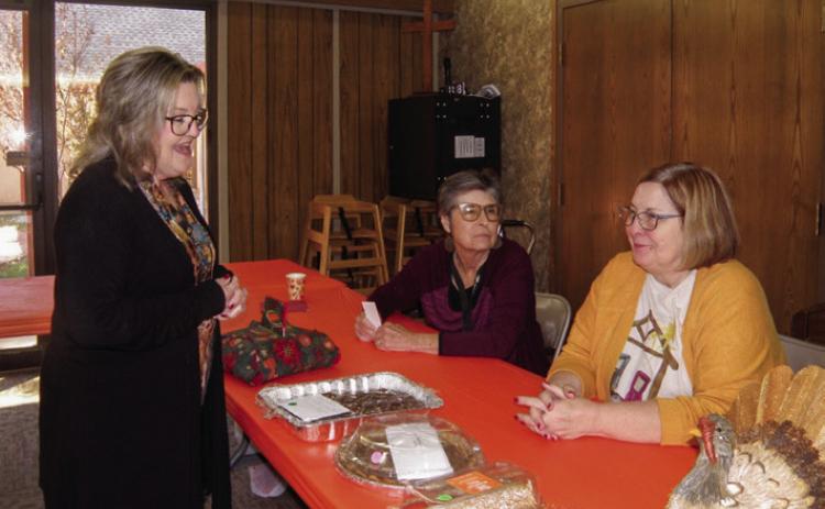 Ann Ricks, standing, visits will Lila Hoobler, left, and Susan Leary prior to selecting a baked dessert at the Childress Methodist Women’s Annual Bazaar and Food Fest Saturday, Nov. 18. Photos by Grace Holman