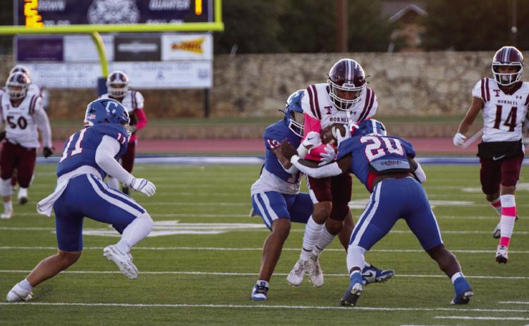 Childress’ Isaiah Jalomo (10) and Da’Reon Mathis (20) take down a Tulia Hornet during the Bobcats’ 56-6 district win Friday, Oct. 13 at Fair Park Stadium. Photo by Childress High School Yearbook Staff