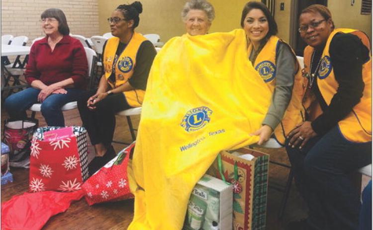 Wellington Lions celebrate the season with a Chinese Christmas gift exchange for their Monday, Dec. 19 meeting. The bright, yellow Lions International stadium blanket, provided by Lion Cynthia Patterson, turned out to be a hot item with Lion Fraya Hammons stealing the treasure for keeps the third time. From left, Nita Day, Patterson, Hammons, Noemi Pena, Angie McDanel. For information on becoming a member of Wellington Lions Club, contact Pena at 806-277-0202. The Red River Sun/Bev Odom