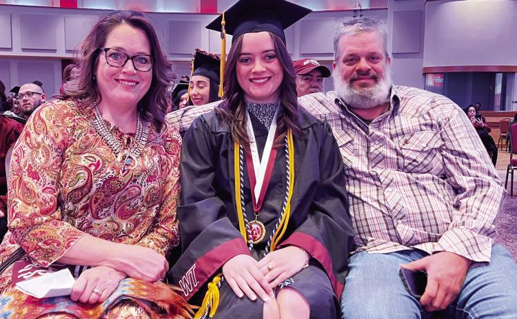 Maryann Heffley, center, accepts congratulations from her parents, Cynthia and Jason Heffley, at the West Texas A&amp;M University Donning of the Stoles ceremony.