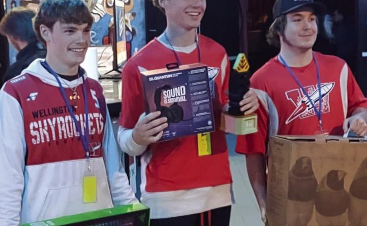 Rocket League team members, including juniors Carson Tarver, left, and Nixon Folk and sophomore Caleb Strickland, receive first place at the Region 16 eSports Invitational.