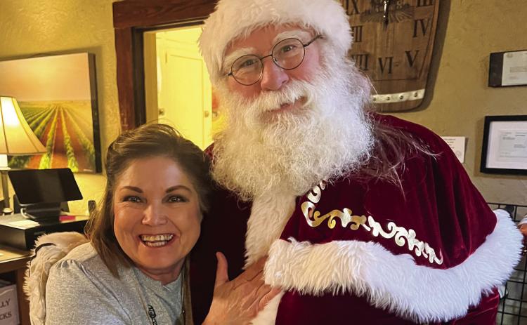 Beverly Smith visits with Santa Claus at The 501 Winery, located in downtown Childress. The Red River Sun/Nicole Dill