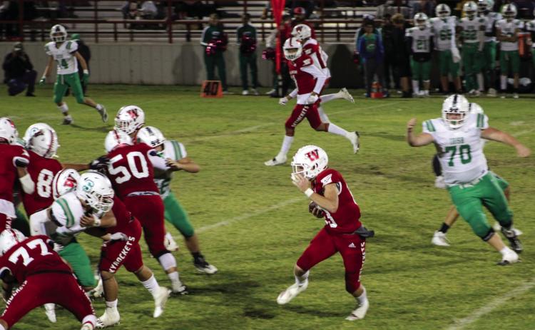 Skyrocket Nixon Folk (13) runs the ball down the field behind Wellington’s offensive line, slipping past the Irish in a district-opening 36-0 shutout. The Red River Sun/Shauna Salinas